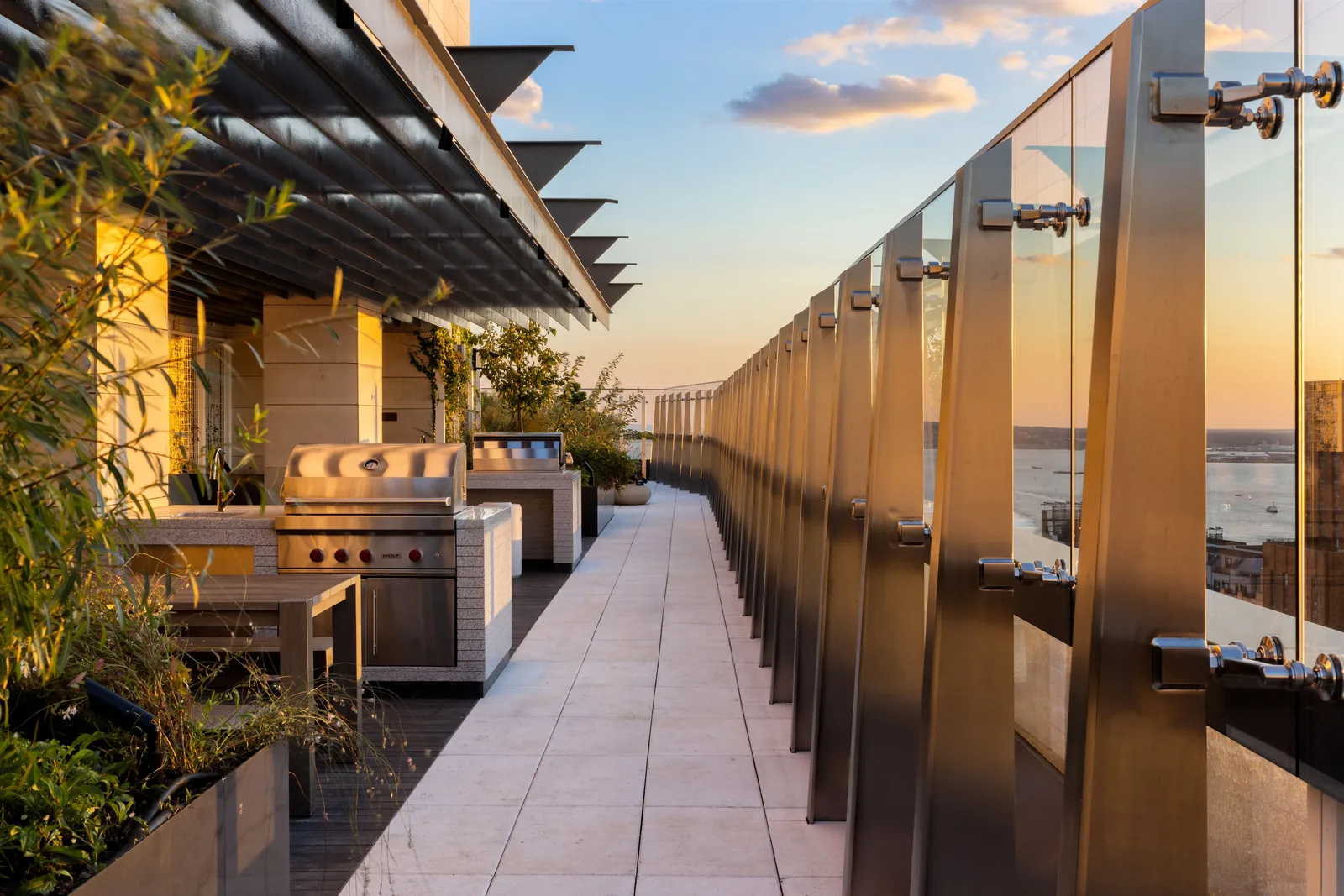 The sunset-facing rooftop terrace with grilling stations and harbor views
