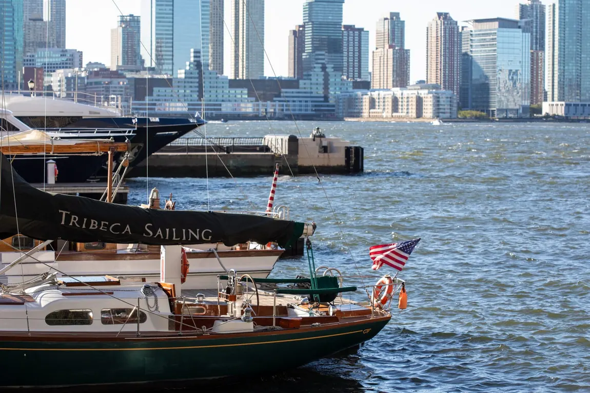 A classic sailing yacht moored at the North Cove marina, harbor beyond