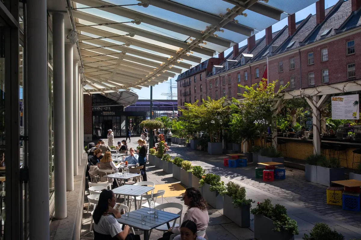 A sunlit Seaport dining terrace