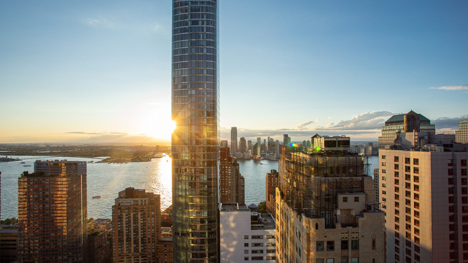 Sunset over the Hudson River framed by downtown towers from 77 Greenwich