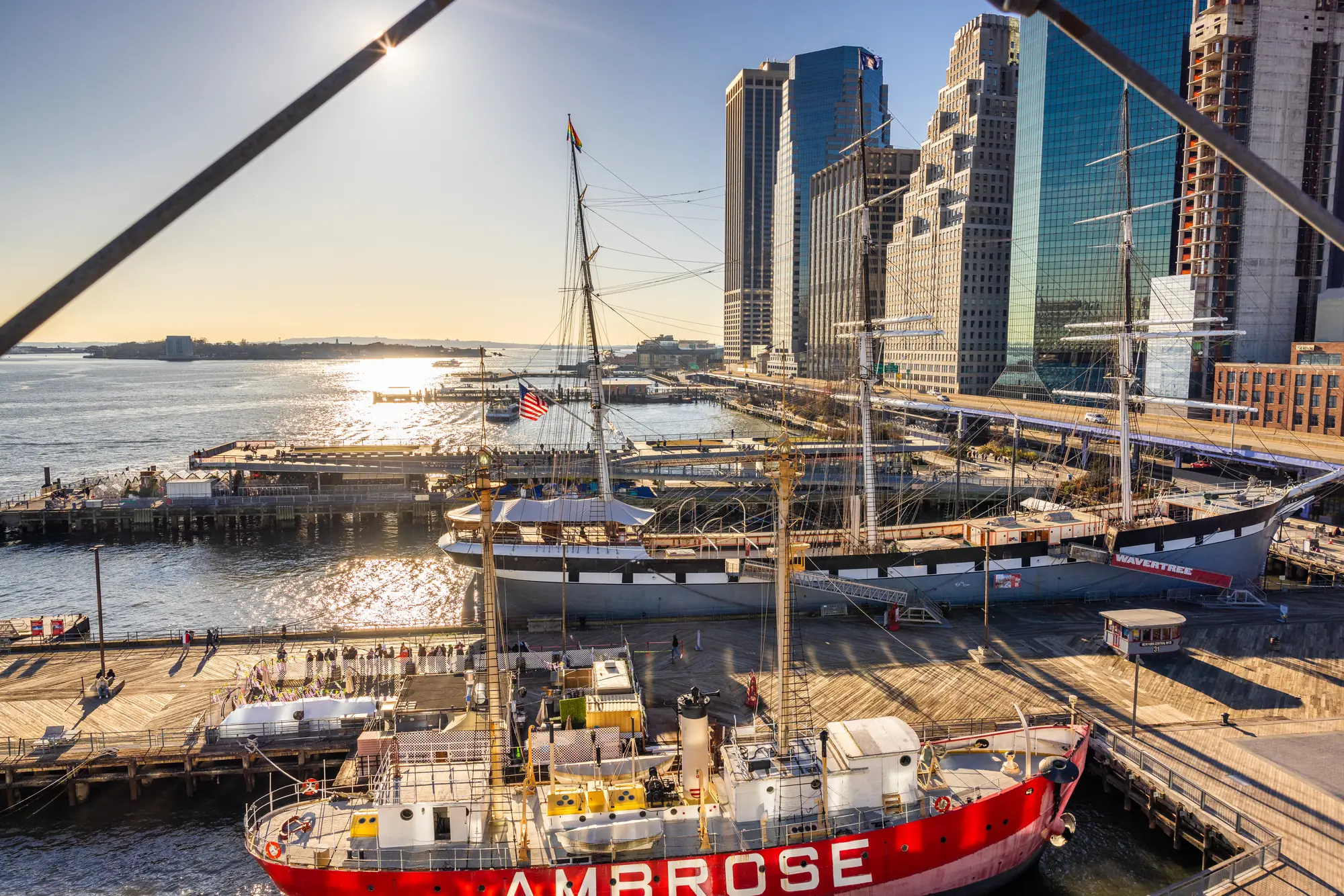 South Street Seaport and the Lower Manhattan skyline at golden hour, seen from the East River
