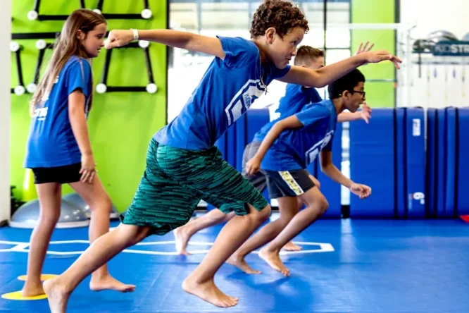 Children cheering during a KidStrong children's fitness class