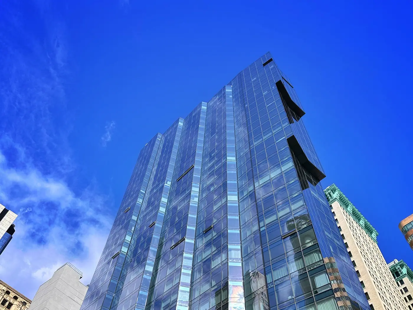 The faceted pleated-glass facade of 77 Greenwich rising above Downtown Manhattan
